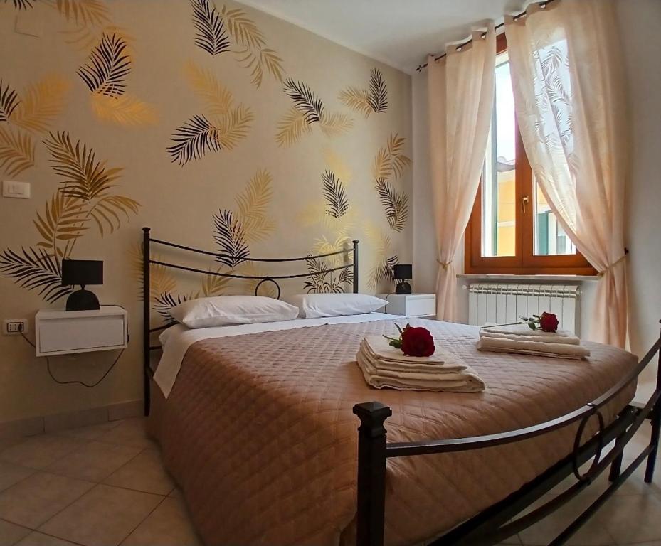 a bedroom with a bed with towels on it at Marruvium 1937's in Avezzano