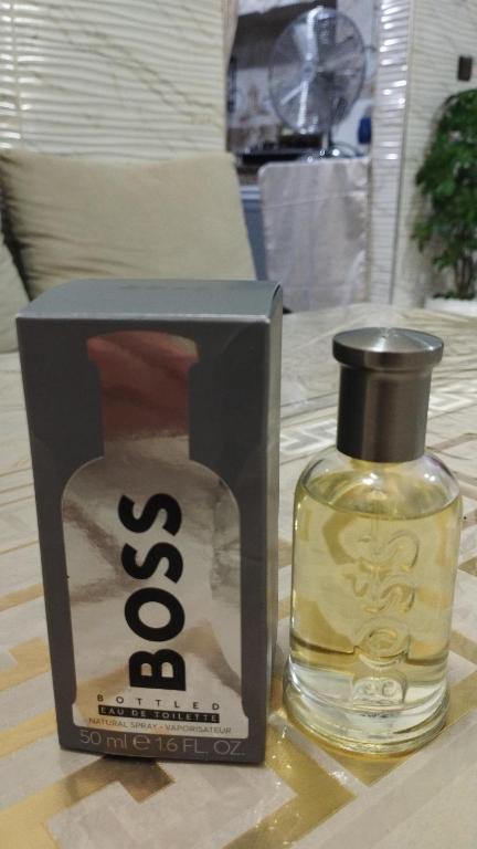 a bottle of whisky in a black box next to a perfume bottle at Mogador in Maarif