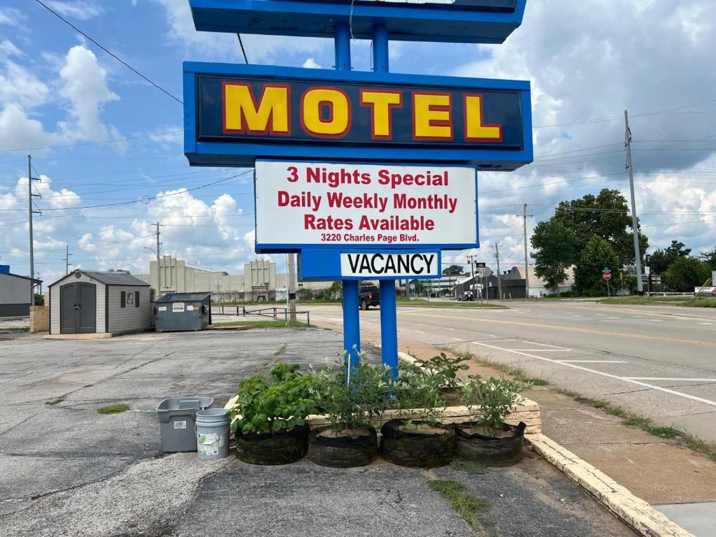 a motel sign on the side of a street at Holiday Motel Tulsa OK in Tulsa