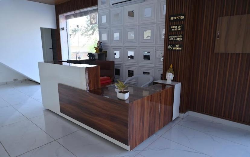 a lobby with a reception desk in a building at Hotel shine plus in Kurukshetra