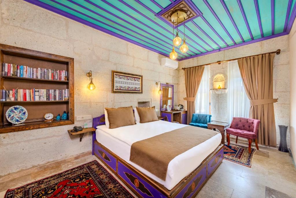 a bedroom with a bed and a book shelf at Arcus Cappadocia in Göreme