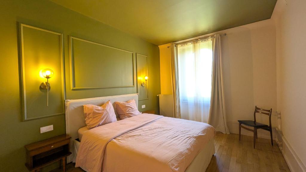 a bedroom with a white bed with a window at Château Foncine in Foncine-le-Bas