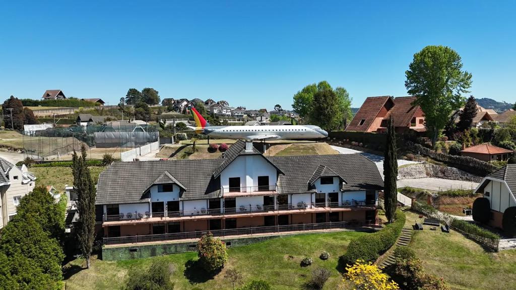 an airplane is sitting on top of a house at Pousada Constellation Lodge in Campos do Jordão