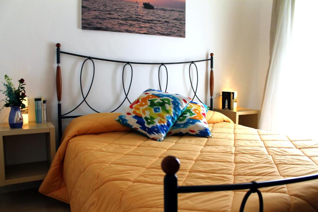 a bedroom with a bed with two pillows on it at Il Vecchio e Il Mare Maratea in Maratea