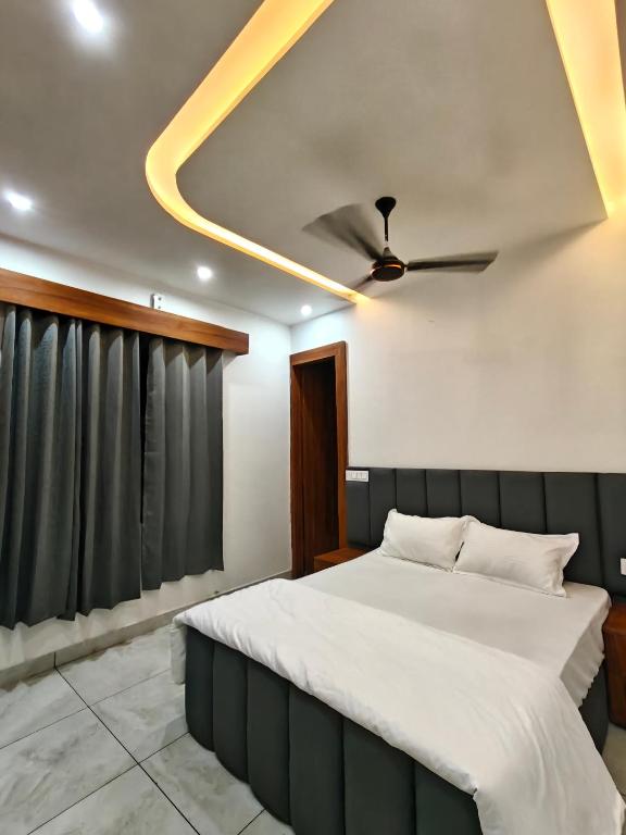 a bedroom with a bed and a ceiling fan at Ora Stay in Pānīpat