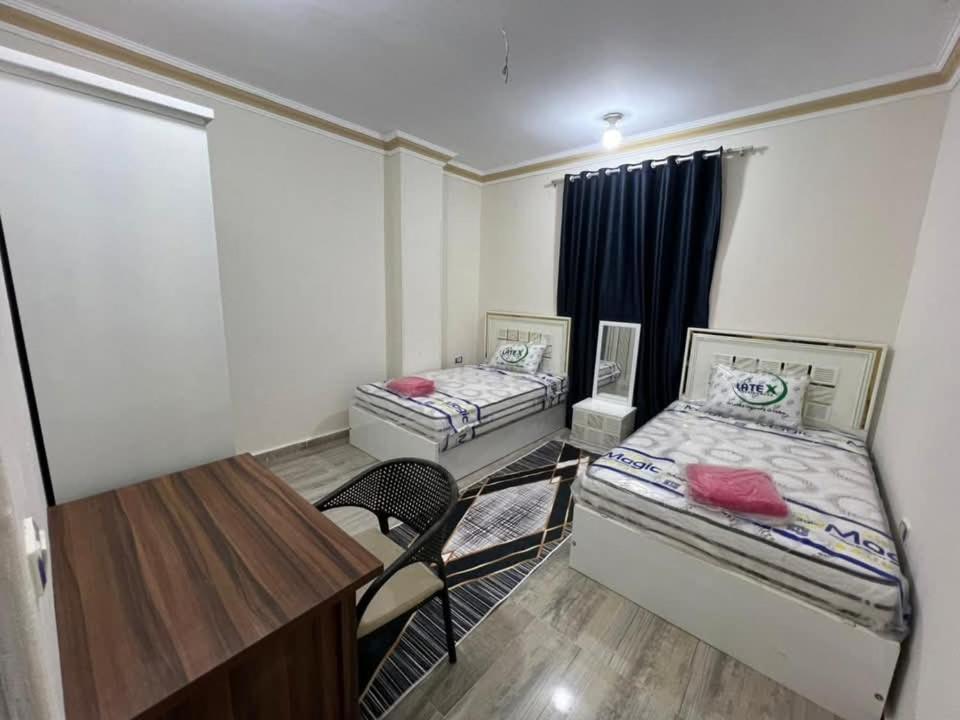 two beds in a room with a table and chairs at Safa A house in Sintrīs