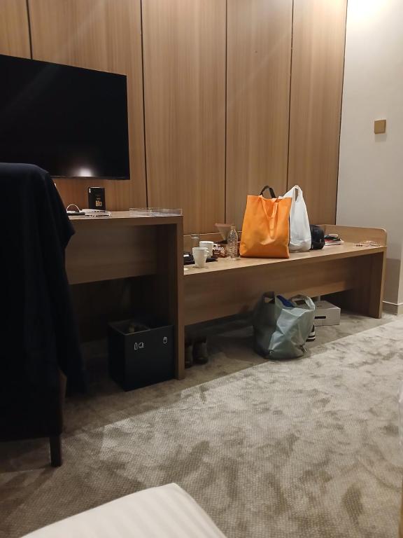 an office desk with an orange bag on it at فندق لوكس جراند in Dubai