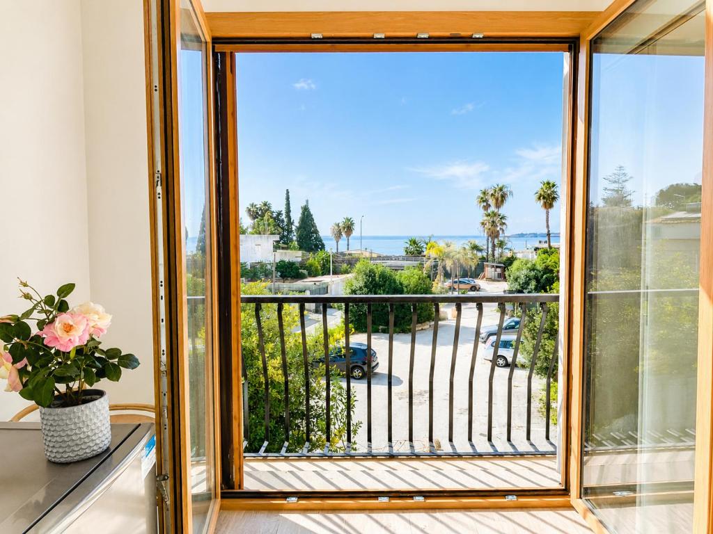 a room with a window with a view of a street at VILLA SEA VIEW IN SICILY, Real Relax in Fontane Bianche