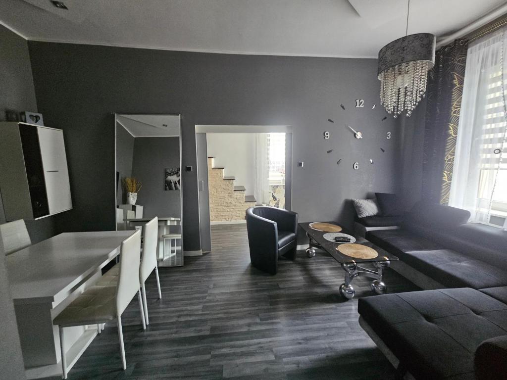 a living room with a couch and a table at Apartament DARIS in Wałbrzych