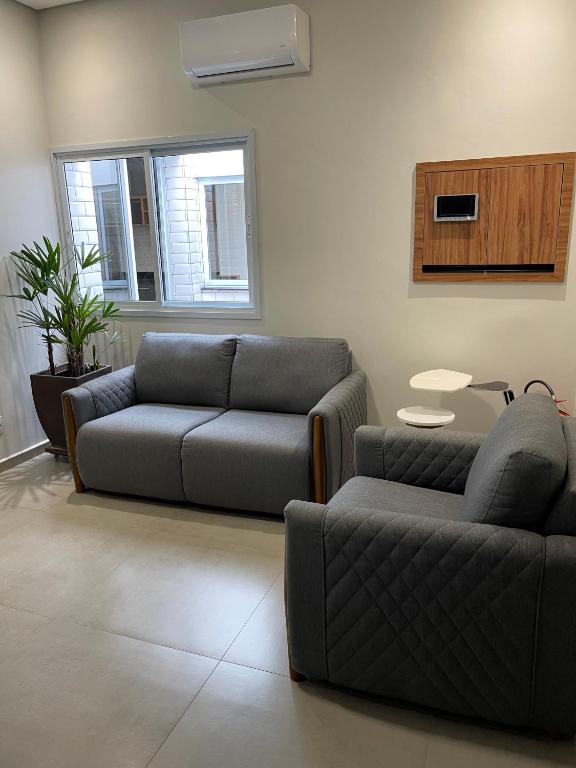 a living room with a couch and a chair at Hostel Mirandopólis in São Paulo