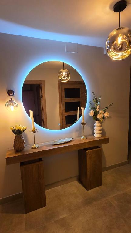 a room with a table with a mirror and candles at Luxury Ría Noia in Noya