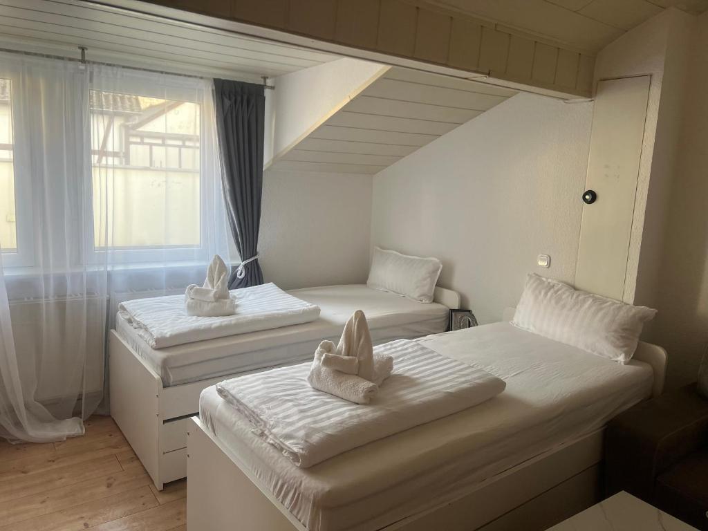 a room with two beds and a window at DADI Apartment in Linz am Rhein