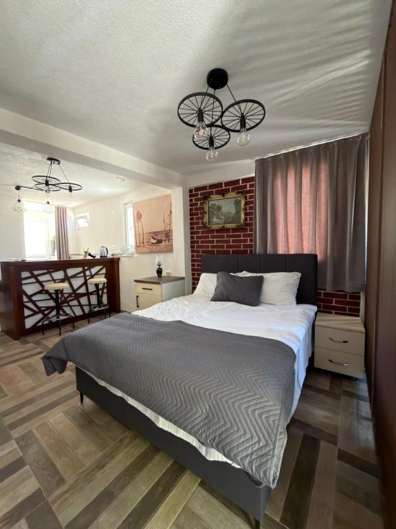 a bedroom with a large bed and a chandelier at Saymon apartment Trpejca in Ohrid