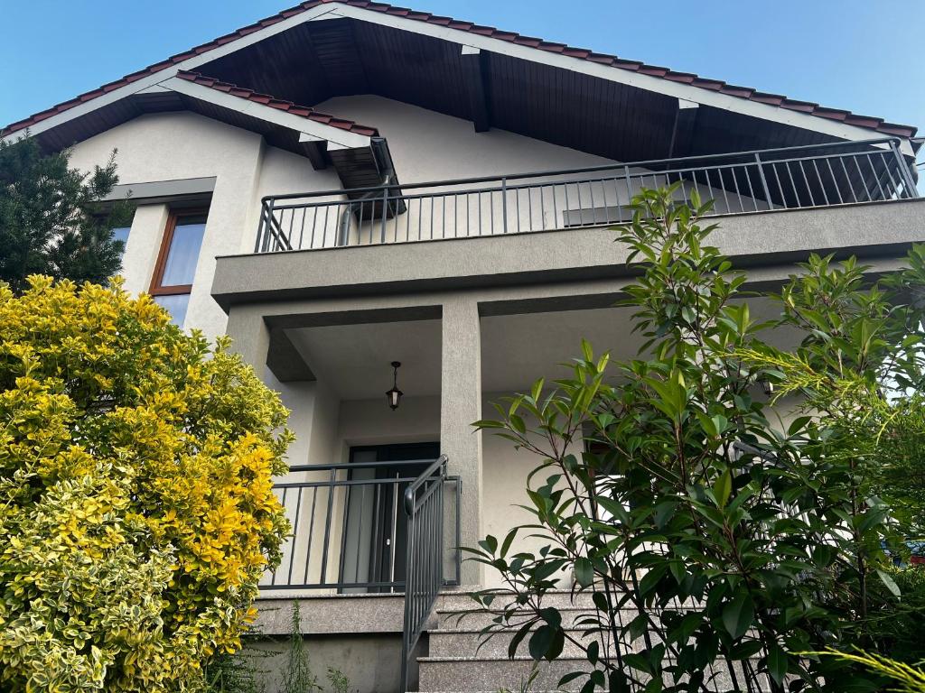 a house with a balcony on the side of it at Rus House in Cluj-Napoca