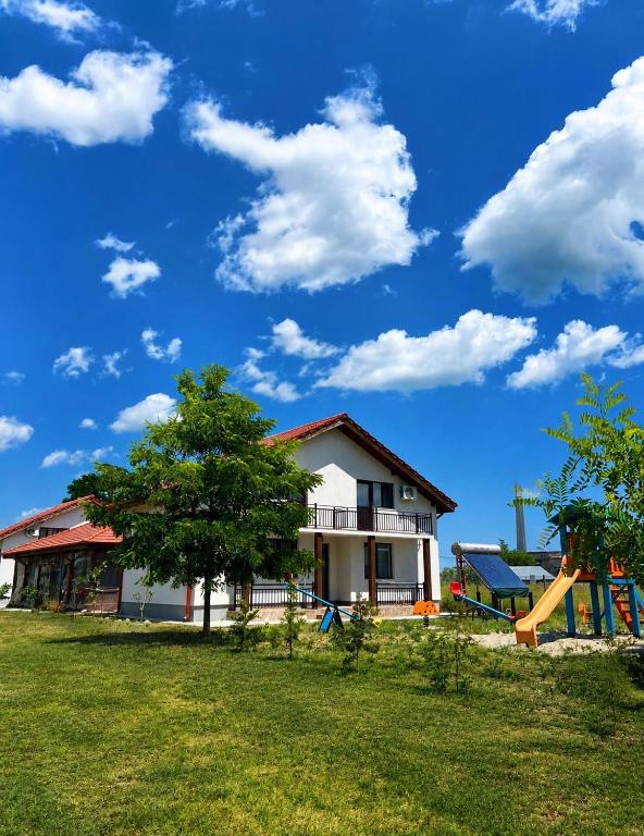 a house with a playground in a yard at Casa Valurile Marii in Sfântu Gheorghe