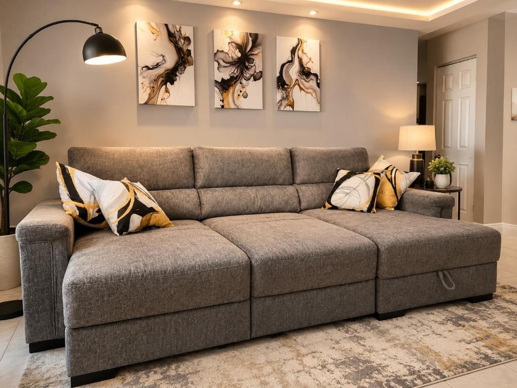 a gray couch in a living room with paintings on the wall at Vacation QJR in Cutler Bay