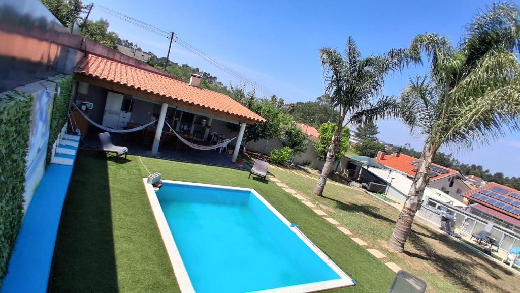 a swimming pool in the yard of a house at Dream House in Aldeia Nova