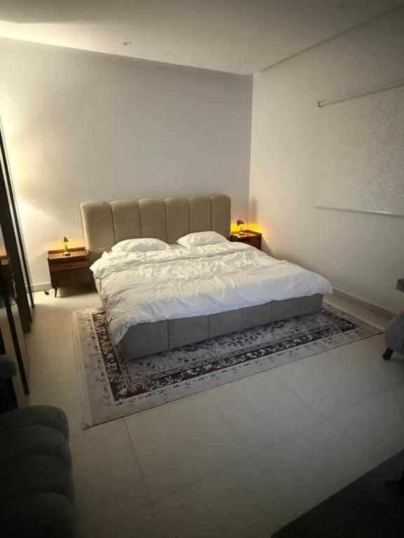 a bedroom with a large bed in a room at Levin in Al Majma'ah