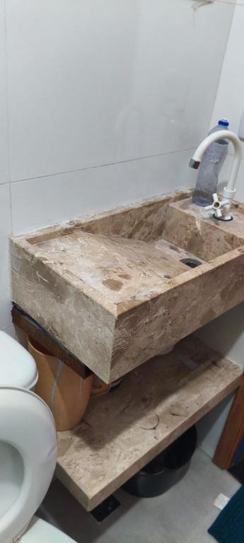 a bathroom with a wooden sink and a toilet at Excelente apartamento aconchegante in Taguatinga