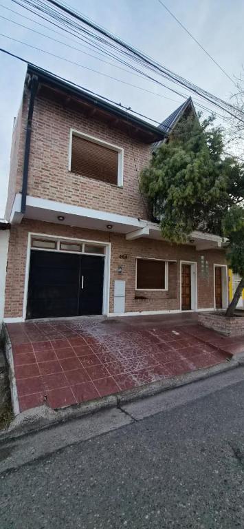 a brick house with two garage doors on a street at Batilana 2 in Neuquén