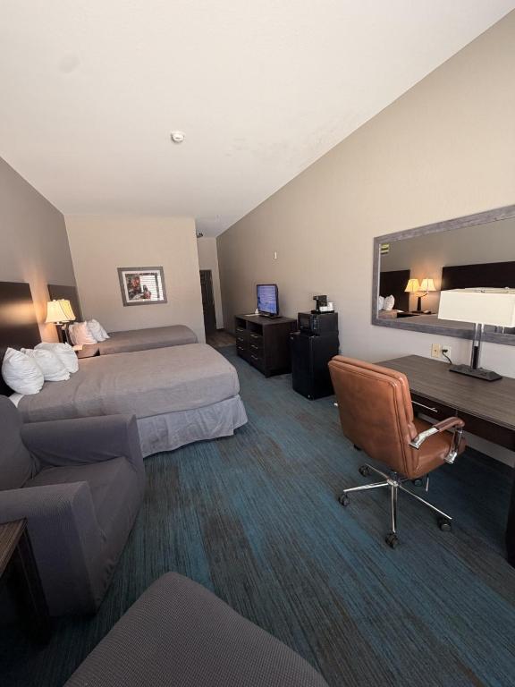a hotel room with two beds and a chair at Sagebrush Hotel in Crystal City