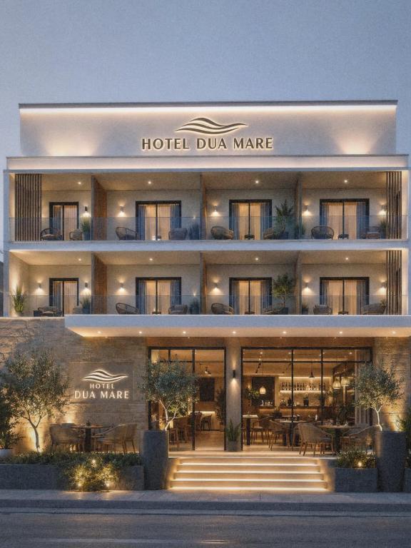 a hotel dunmaire building with a lit up facade at Hotel Duamare LIVADHI in Himare