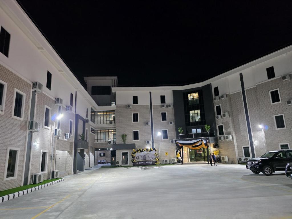 an empty parking lot in a building at night at Movela Hotels in Warri