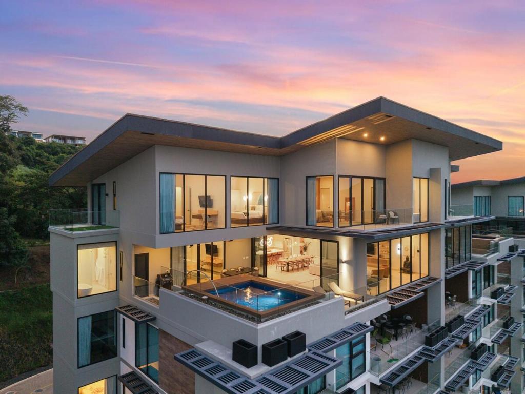 an aerial view of a house with a sunset at Oceanview Penthouse - Private Pool - Reserva Conchal in Playa Conchal
