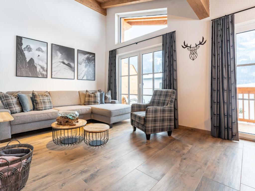 a living room with a couch and a table at Chalet Aquila in Niedernsill