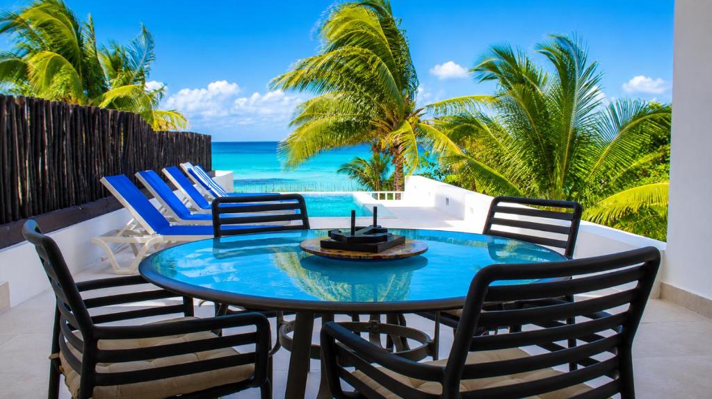 a patio with a table and chairs and the ocean at Villa Cos beachfront house in San Benito