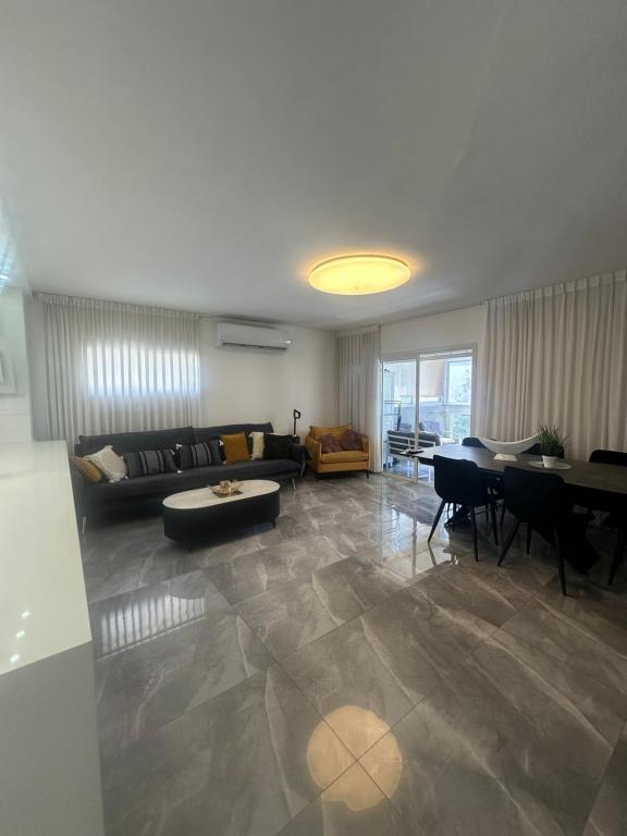 a living room with a couch and a table at Beachfront Haven - Perfect for Groups in Ashdod