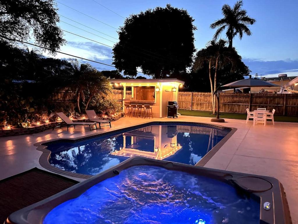 a swimming pool in the middle of a yard at Jupiter Heated Pool/Spa Luxury 3Bed Home in Jupiter