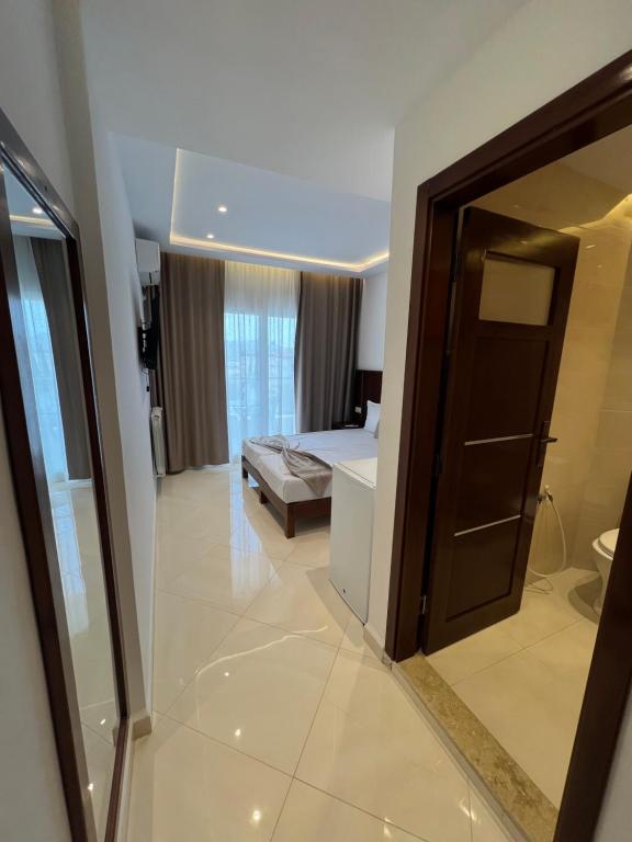 a hotel room with a bed and a mirror at Hotel bouzeriba in El Kala