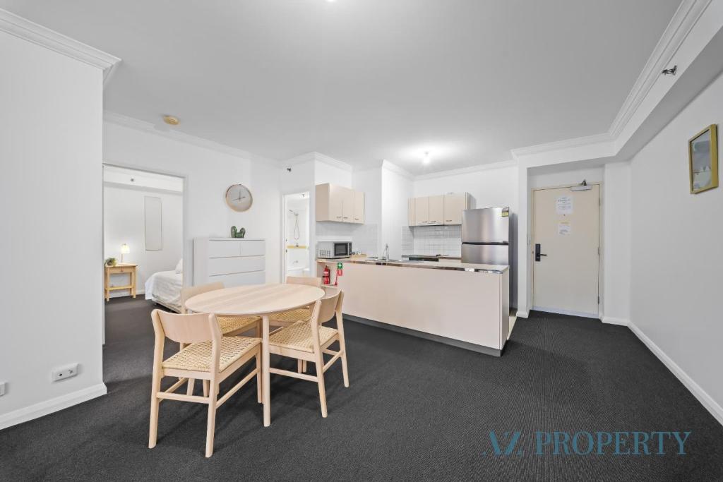 a kitchen and dining room with a table and chairs at Perth CBD Hideaway Walk to Everything in Perth