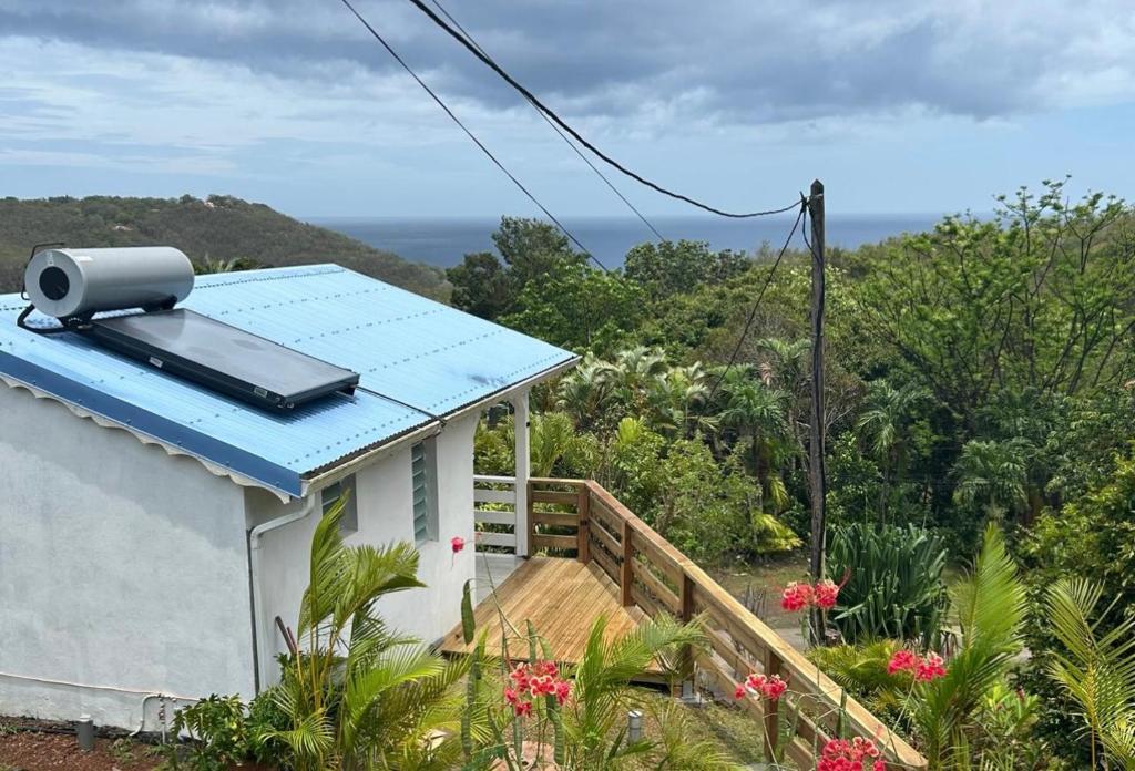 a small house with a solar panel on the roof at Bungalow Kaz à Céli in Deshaies