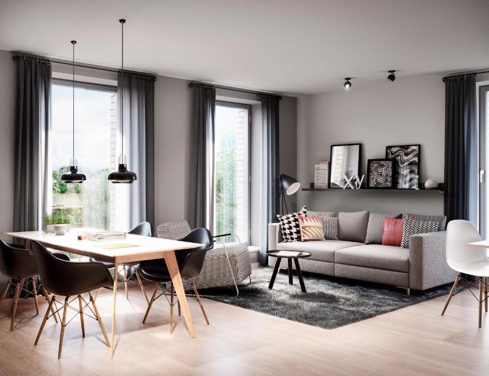 a living room with a table and a couch at Bett&Bude Boardinghouse in Westerland