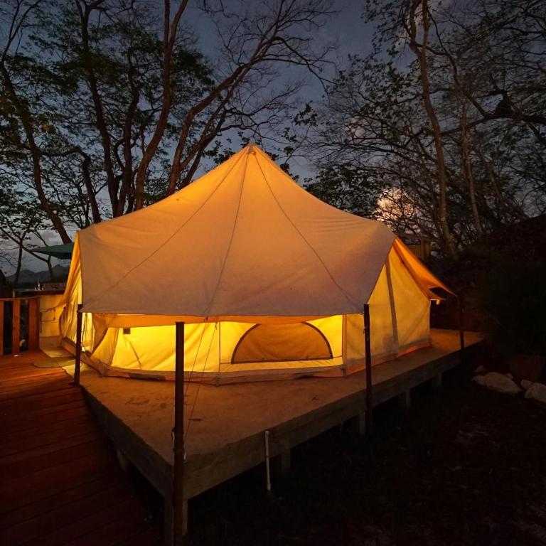 a tent that is lit up at night at GuanaGlamp in Tamarindo