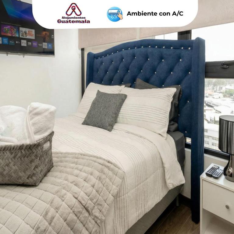 a bed with a blue headboard in a room at Ceiling INARA 1503 B in Guatemala
