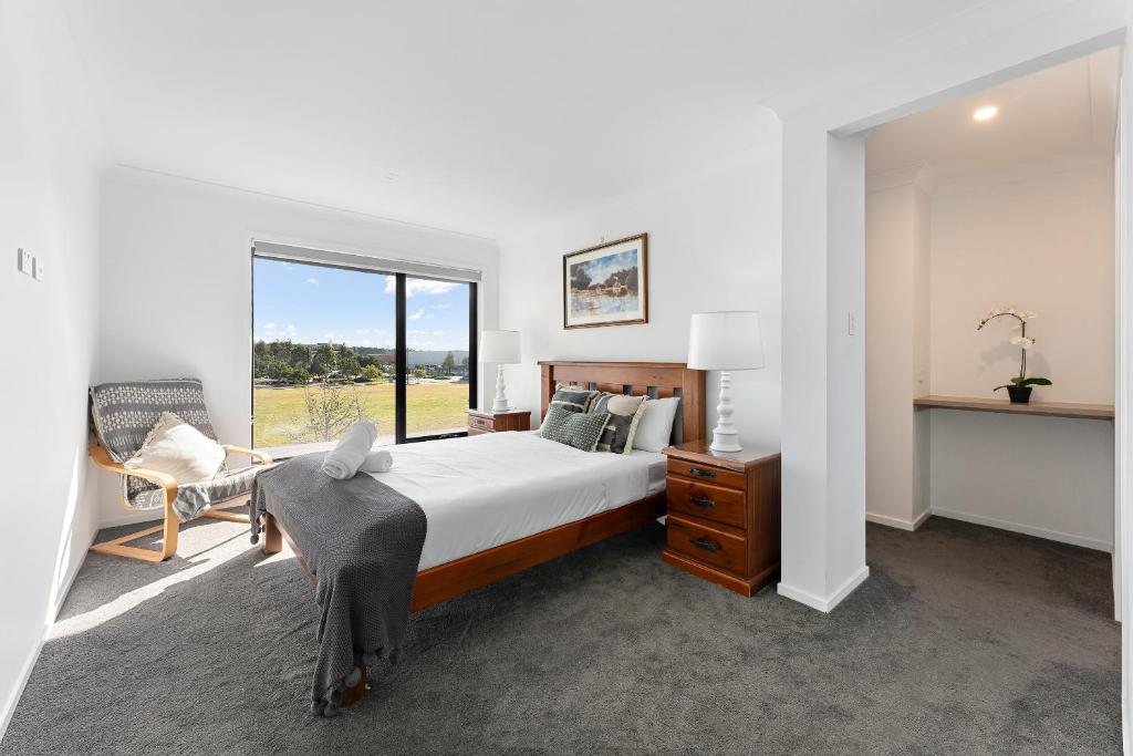 a bedroom with a large bed and a window at Homenest in Gledswood Hills