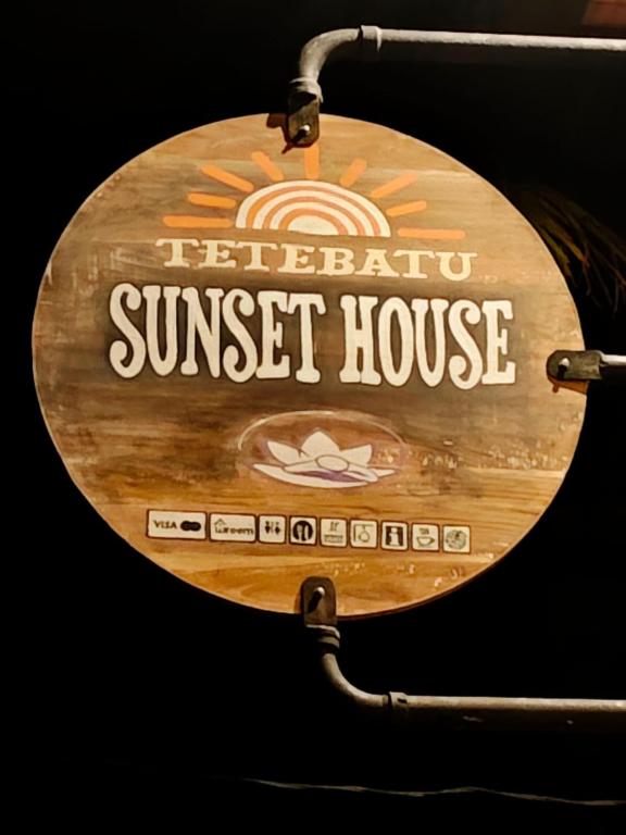 a sign for a sunset house on a table at Tetebatu Sunset House in Tetebatu