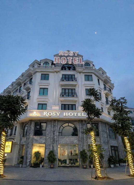 a hotel with a sign on the front of it at Rosy Hotel in Hanoi