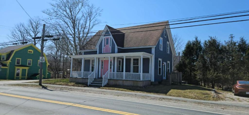 a blue and green house on the side of a street at The Stirton House in Shelburne