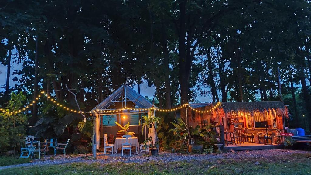 a backyard with a gazebo with lights at night at Slove U House in Khon Kaen