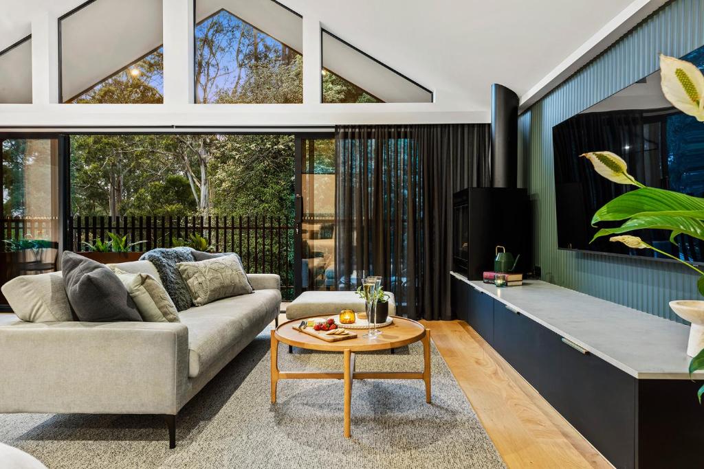 a living room with a couch and a table at The Sett in Sassafras