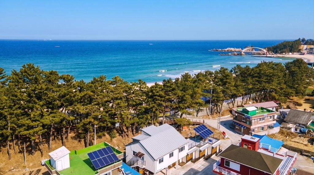an aerial view of a beach with houses and the ocean at Samcheok ara Pension in Samcheok