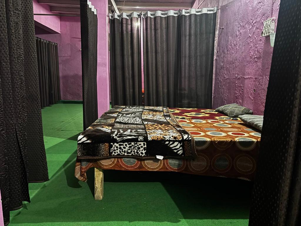 a bedroom with a bed in a purple room at Brijwasi Seva Sadan in Mathura