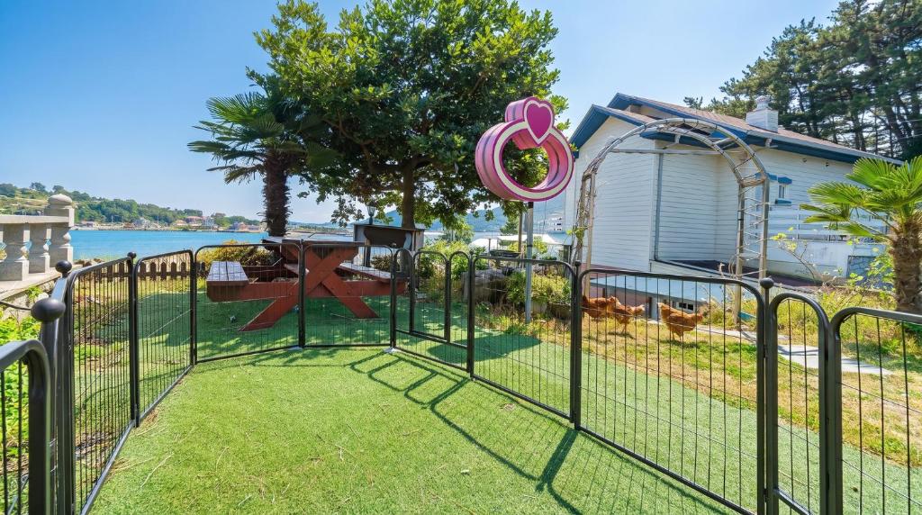 a gate in a yard with a playground at Geoje Youngsu Pension in Geoje