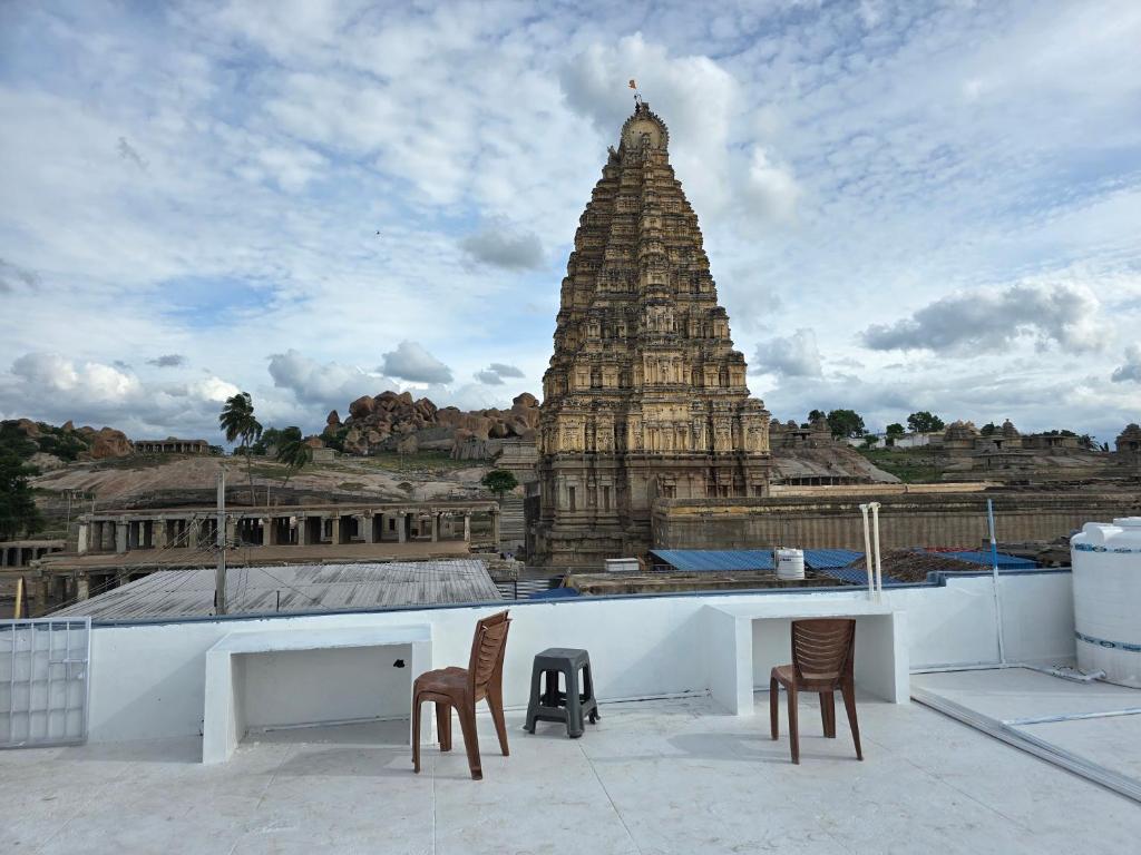 two chairs and a table on top of a building at TEMPLE VIEW GUEST HOUSE in Hampi