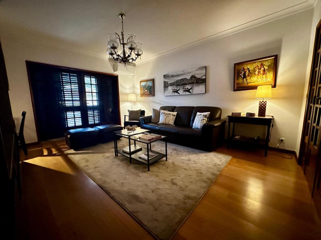 a living room with a couch and a table at Central Home Arouca in Arouca