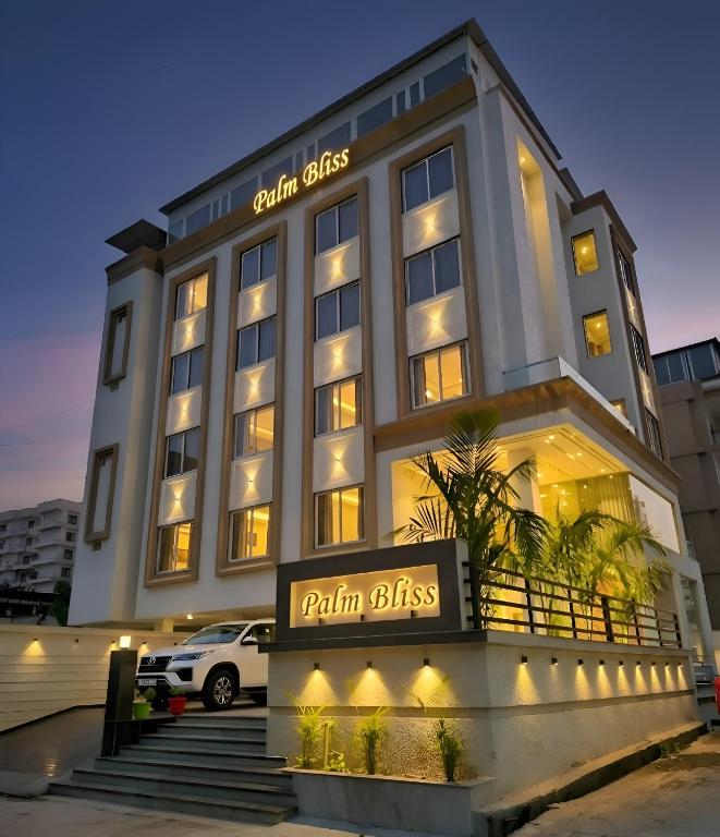 a hotel with a sign in front of a building at Palm Bliss A Luxury Hotel in Haridwār